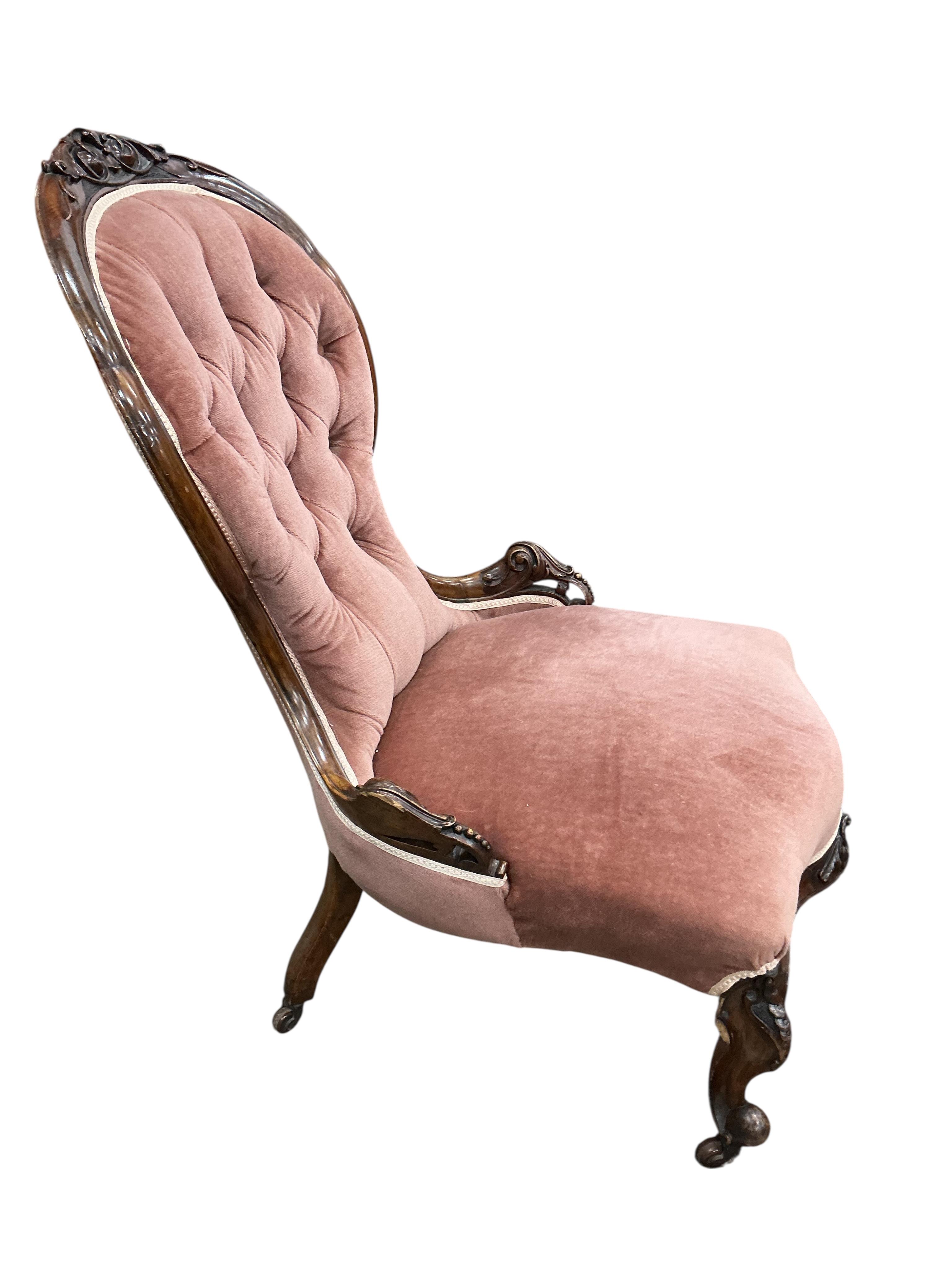 A Victorian mahogany spoon back nursing chair and a circular footstool, diameter 60cm